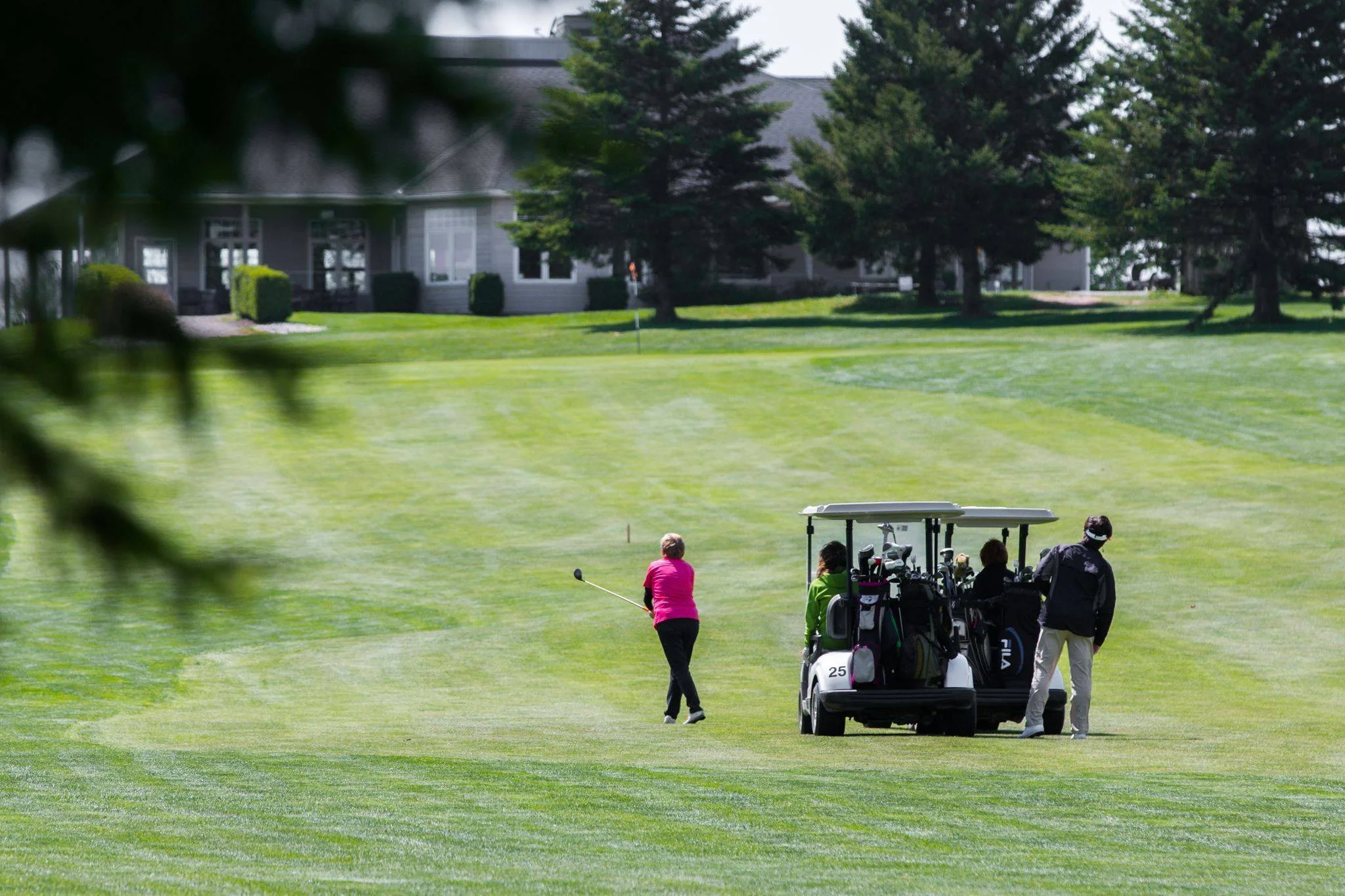 Golf tournament planning checklist on a clipboard beside a golf ball on the green.