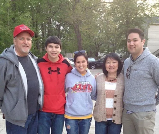 Tom and Gabe Lammers with family members smiling together outdoors.