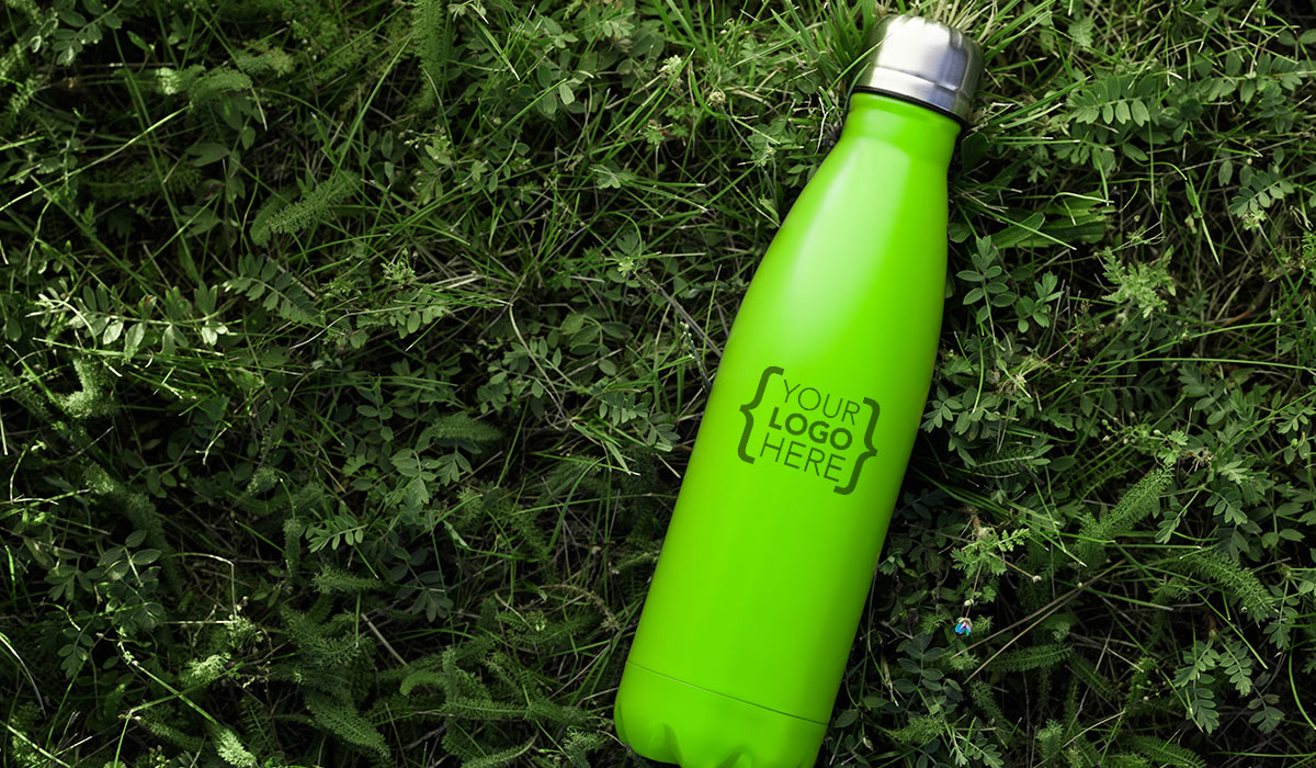 Green water bottle on grass with logo placement positiont