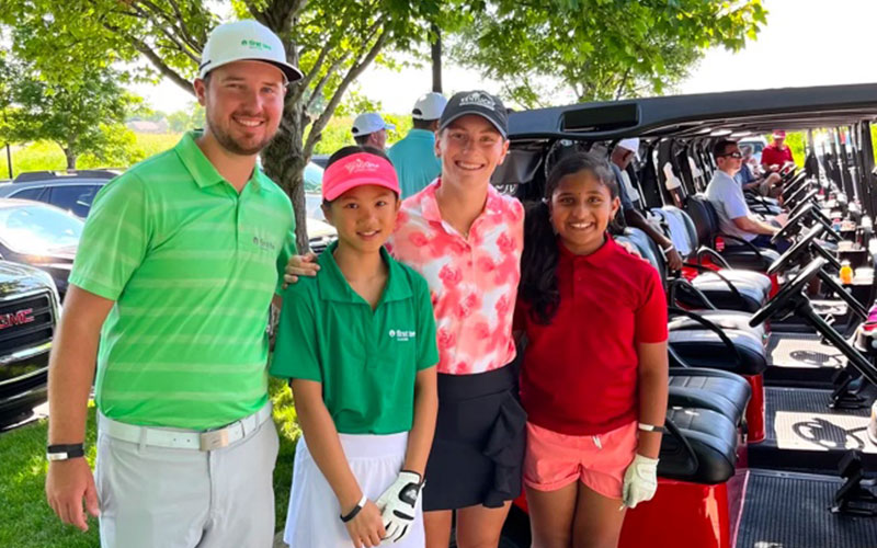 Family of four at golf tournament