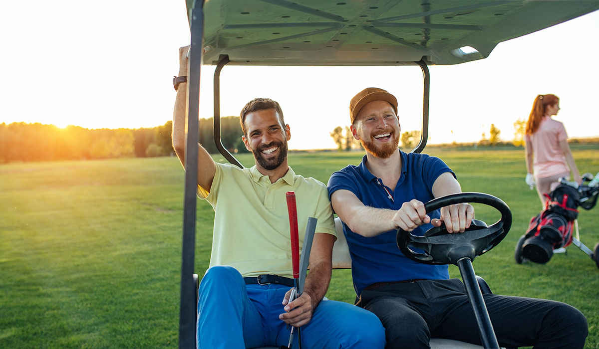 Men riding in golf cart