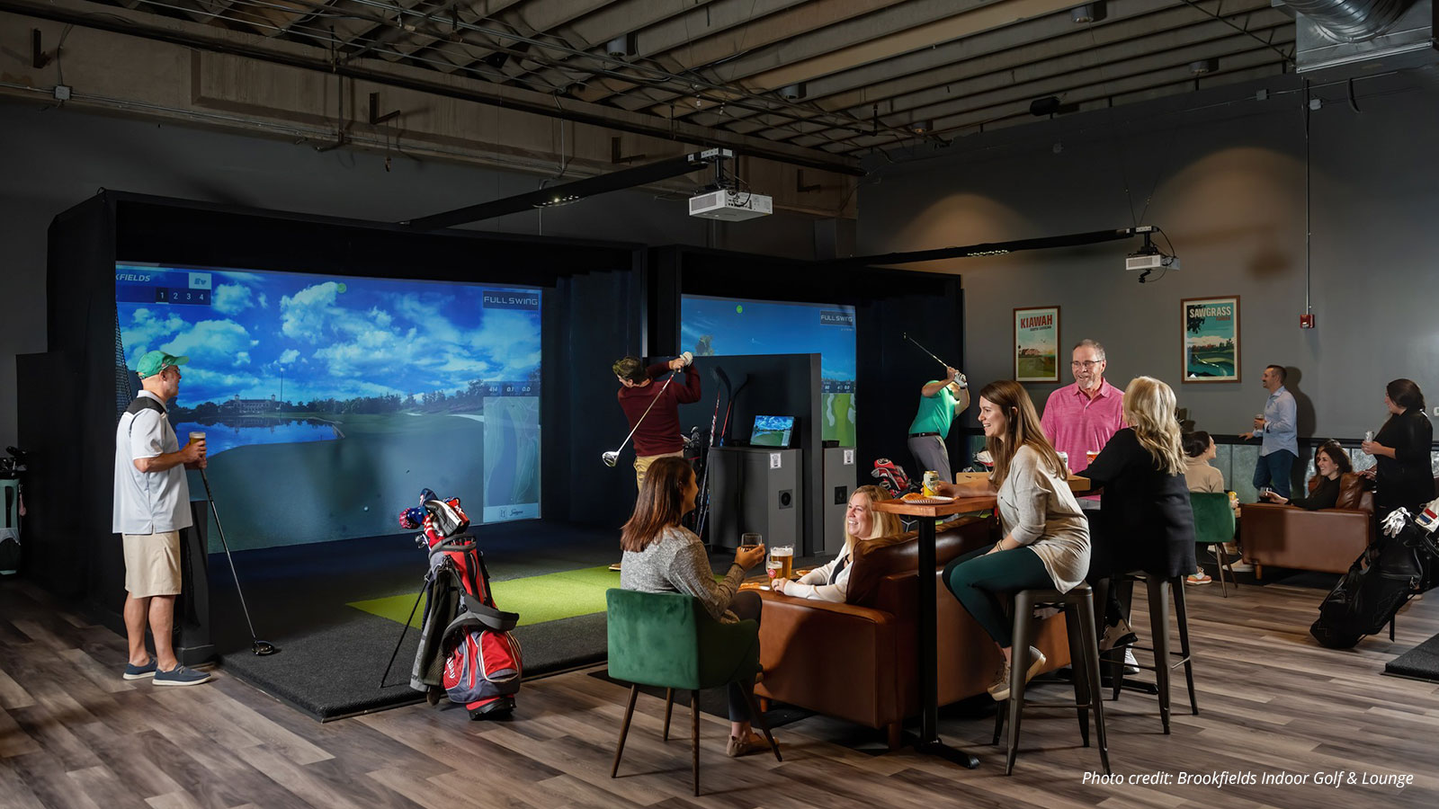 People at indoor virtual golf facility